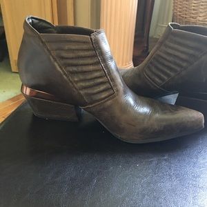 Unique, distressed brown leather boots.